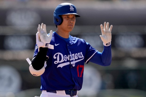 Dodgers' Shohei Ohtani calls time after hitting a double against the Diamondbacks during the first inning of a spring training game on March 10, 2025, in Phoenix. (AP Photo/Matt York)