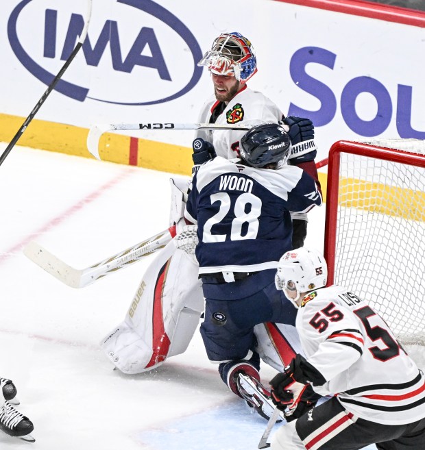 Avalanche's Miles Wood collides with Hawks goalie Spencer Knight during the second period at Ball Arena in Denver on March 10, 2025. (Photo by AAron Ontiveroz/The Denver Post)