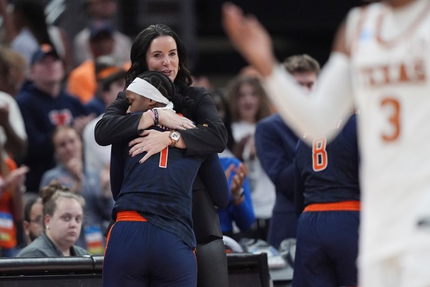 Illinois guard Genesis Bryant (1) is hugged by head coach Shauna Green during the final seconds of their loss to Texas in the NCAA college basketball tournament in Austin, Texas, Monday, March 24, 2025. (AP Photo/Eric Gay)