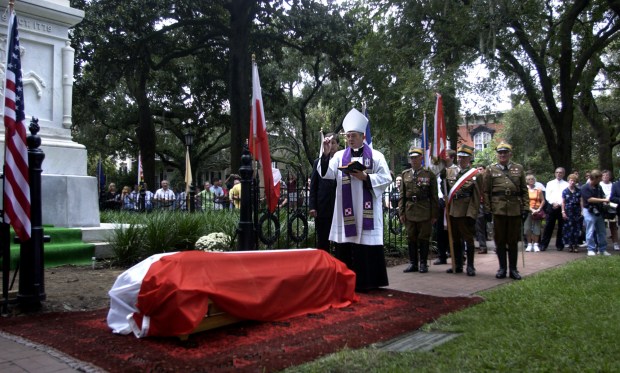 Polish Bishop Tadeusz Pwoski sprinkles holy water on the casket of Brig. Gen. Casimir Pulaski Sunday Oct. 9, 2005 at the Pulaski Monument in Monterey Square in Savannah, Ga., on the 226th anniversary of the Revolutionary War battle in which he was slain. The Polish nobleman regarded as the father of the American cavalry was buried with military honors. The bones were exhumed by the local coroner in 1996 in hopes DNA tests would prove they were Pulaski's remains. Inconclusive results failed to settle a long-standing debate over whether Pulaski was buried at sea or in a secret grave to protect his remains from desecration. The unsolved mystery did not halt the funeral. (AP Photo/Stephen Morton)(AP Photo/Stephen Morton)