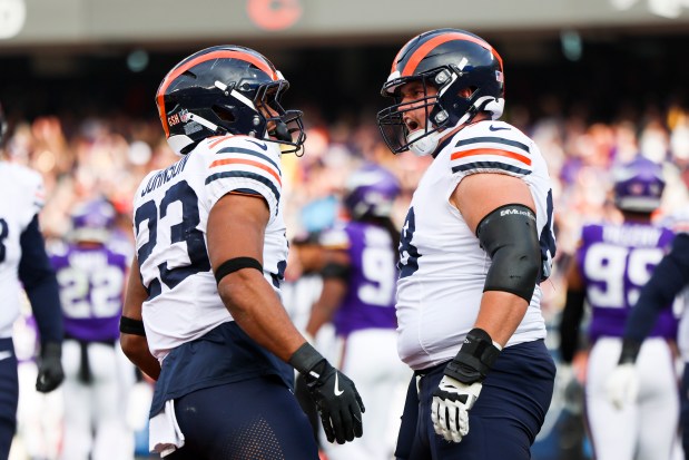 Bears running back Roschon Johnson (23) celebrates his touchdown against the Vikings with center Doug Kramer Jr. on Nov. 25, 2024, at Soldier Field. (Eileen T. Meslar/Chicago Tribune)