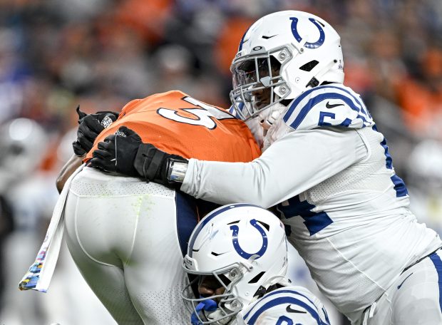 Broncos quarterback Russell Wilson (is sacked by the Colts' Dayo Odeyingbo (54) and Yannick Ngakoue on Oct. 6, 2022, in Denver. (AAron Ontiveroz/The Denver Post)