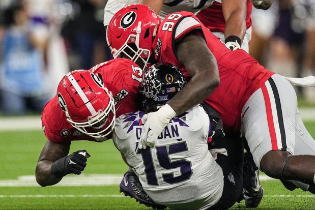 Georgia defensive linemen Mykel Williams (13) and Bear Alexander (99) sack TCU quarterback Max Duggan during the College Football Playoff national championship game Jan. 9, 2023, in Inglewood, Calif. (AP Photo/Mark J. Terrill)