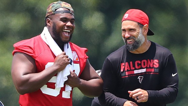 Grady Jarrett shares a laugh with linebackers coach Jeff Ulbrich during Falcons training camp in 2020. (Curtis Compton/The Atlanta Journal-Constitution)