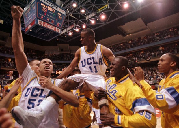 Tyus Edney is carried by celebrating UCLA teammates J.R. Henderson, left, and Ike Nwankwo after sinking the winning basket to beat Missouri 75-74 in the second round of the NCAA Tournament on March 19, 1995, in Boise, Idaho. (AP Photo/Bill Haber)