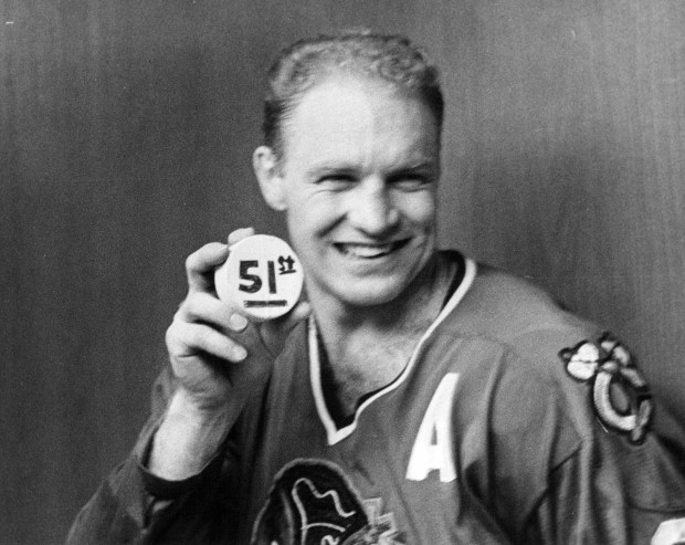 Bobby Hull proudly displays a puck in March 1966, symbolic of his highest scoring effort in a single season. (Chicago Tribune archive)