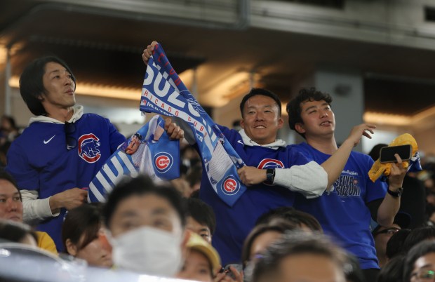 Cubs fans dance and cheer at the start of the eighth inning of an exhibition game between the Cubs and Yomiuri Giants at the Tokyo Dome on March 16, 2025, in Tokyo. (John J. Kim/Chicago Tribune)