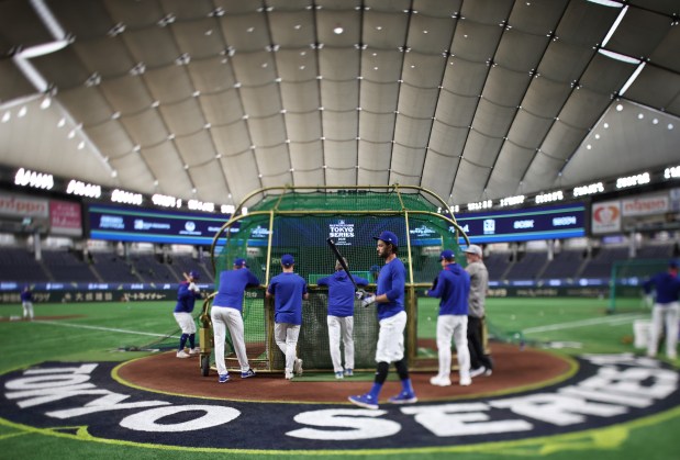 Cubs shortstop Dansby Swanson, center right, waits for his turn at batting practice during a workout at the Tokyo Dome on March 17, 2025, in Tokyo. The Cubs play the Dodgers on March 18 in Tokyo to start the regular season. (John J. Kim/Chicago Tribune)