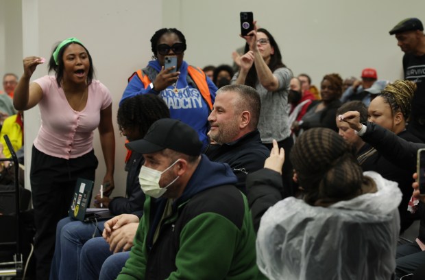 Fraternal Order of Police President John Catanzara, center, is heckled by attendees after speaking about Andrea Kersten, chief administrator of the Civilian Office of Police Accountability, during the public comments section of the Chicago Police Board meeting at police headquarters, April 18, 2024. (John J. Kim/Chicago Tribune)