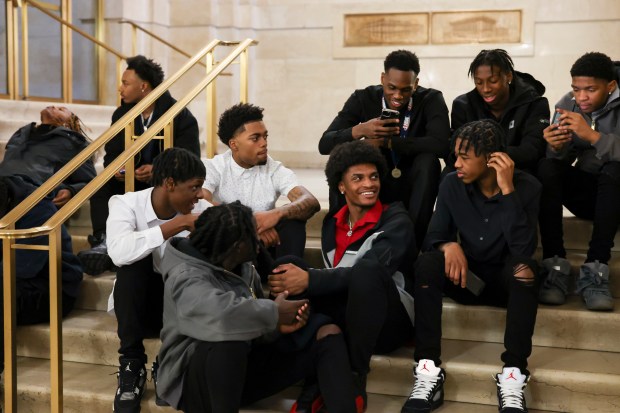 Dyett High School basketball players hang out in City Hall, March 20, 2025, after being honored by Mayor Brandon Johnson on their high school state championship. (Eileen T. Meslar/Chicago Tribune)