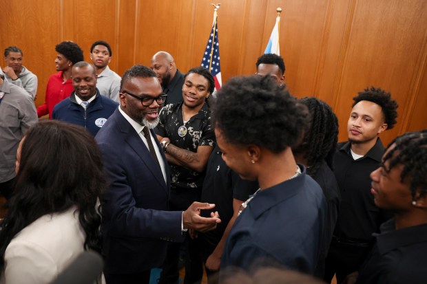 Mayor Brandon Johnson congratulates members of the Dyett High School basketball team on their high school state championship in the mayor's ceremonial office at City Hall on March 20, 2025. (Eileen T. Meslar/Chicago Tribune)