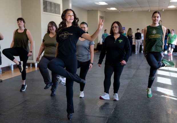 Riverdance performer Brianna Doran, center, leads an Irish dance workshop, March 17, 2025, on St. Patrick's Day at the Irish American Heritage Center. (Brian Cassella/Chicago Tribune)