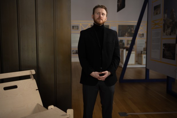 Zachary Dmyterko, the new director of Chicago's Ukrainian National Museum, poses for a portrait in the new exhibit "Constructing Hope: Ukraine" at the Chicago Architecture Center on March 6, 2025. (Audrey Richardson/Chicago Tribune)