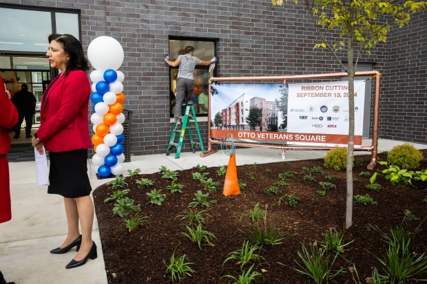 Danita Childers, executive director of the Housing Authority of Cook County, talks to attendees before a ribbon-cutting ceremony held by the Housing Authority to unveil the new Otto Veterans Square housing in Chicago Heights on Sept. 13, 2024. (Tess Crowley/Chicago Tribune)