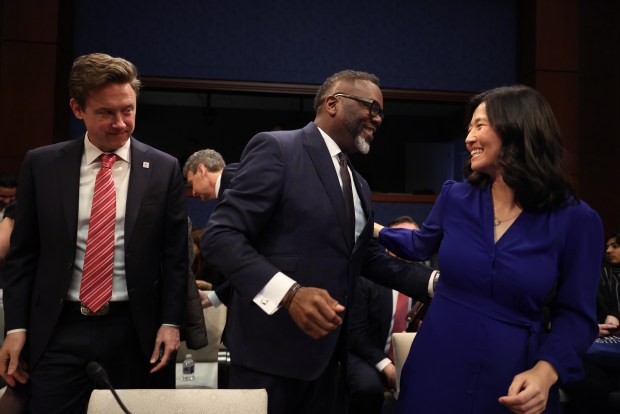 Chicago Mayor Brandon Johnson greets Boston Mayor Michelle Wu before speaking with mayors in front of the House Committee on Oversight and Government Reform, March 5, 2025, in Washington. At left is Denver Mayor Mike Johnston. (Brian Cassella/Chicago Tribune)