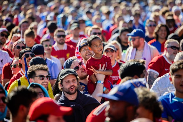 Fans watch a soccer match between Liverpool and Bournemouth on giant TV screens at the Premier League Mornings Live Fan Fest in Lincoln Park in Chicago on Sept. 21, 2024. (Tess Crowley/Chicago Tribune)