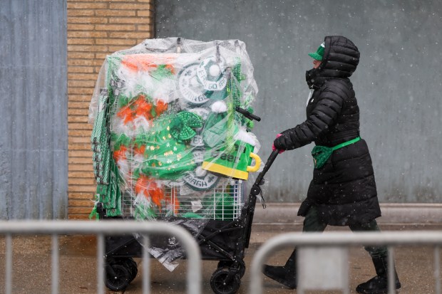 A person pushes a cart full of St. Patrick's Day merchandise along Western Avenue during the South Side Irish Parade in Beverly and Morgan Park. (Eileen T. Meslar/Chicago Tribune)