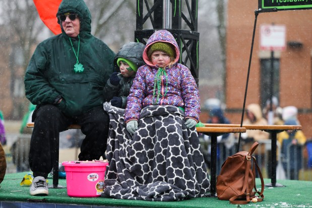 Children are bundled up as they ride on a float in the South Side Irish Parade on Western Avenue in Beverly and Morgan Park on March 16, 2025. (Eileen T. Meslar/Chicago Tribune)