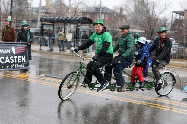 People ride a bike on Western Avenue in the South Side Irish Parade in Beverly and Morgan Park on March 16, 2025. (Eileen T. Meslar/Chicago Tribune)