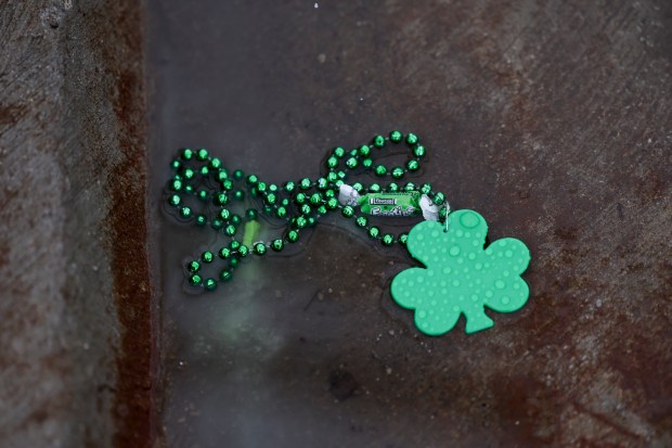 Beads and candy sit in a puddle on Western Avenue after the South Side Irish Parade in Beverly and Morgan Park. (Eileen T. Meslar/Chicago Tribune)