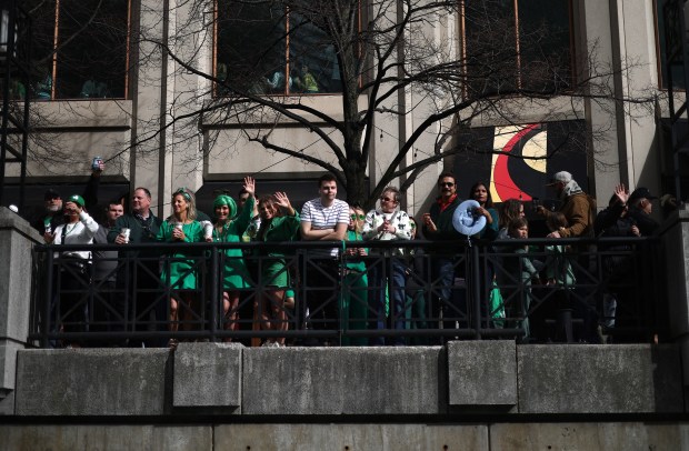 Spectators line the Chicago River as it is dyed green by Chicago Journeymen Plumbers Local 130 to celebrate St. Patrick's Day, March 15, 2025. in Chicago. (Audrey Richardson/Chicago Tribune)