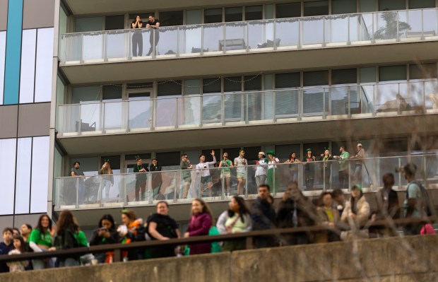 Spectators line the Chicago River as it is dyed green by Chicago Journeymen Plumbers Local 130 to celebrate St. Patrick's Day, March 15, 2025. in Chicago. (Audrey Richardson/Chicago Tribune)