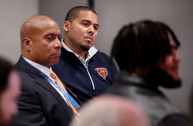 Bears general manager Ryan Poles, center, and President Kevin Warren, left, listen in as new players Drew Dalman and Dayo Odeyingbo, right, are introduced at Halas Hall on March 13, 2025, in Lake Forest. (Chris Sweda/Chicago Tribune).