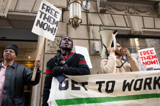 Cordell Williams, center, who served 28 years for a murder before having his conviction overturned, participates in a rally on Jan. 30, 2025, outside an appearance by Cook County State's Attorney Eileen O'Neill Burke at the Union League Club. (Brian Cassella/Chicago Tribune)