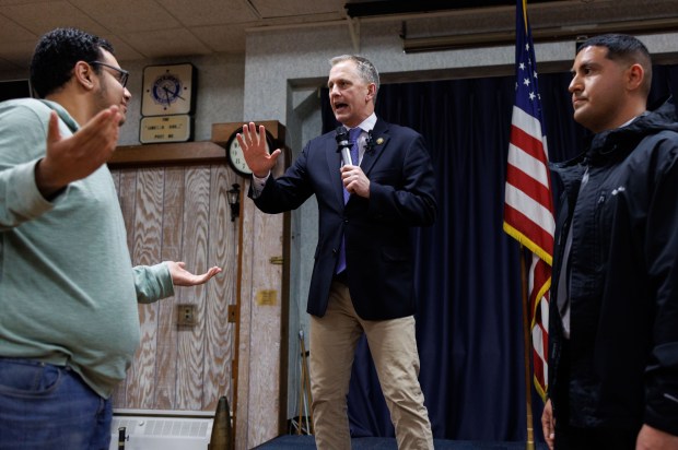 A pro-Israel supporter, left, confronts U.S. Rep. Sean Casten while disrupting a town hall at American Legion Post 80, March 19, 2025, in Downers Grove. After this protester and several pro-Palestinian protesters interrupted Casten, the town hall was shut down by the Downers Grove police. (Armando L. Sanchez/Chicago Tribune)