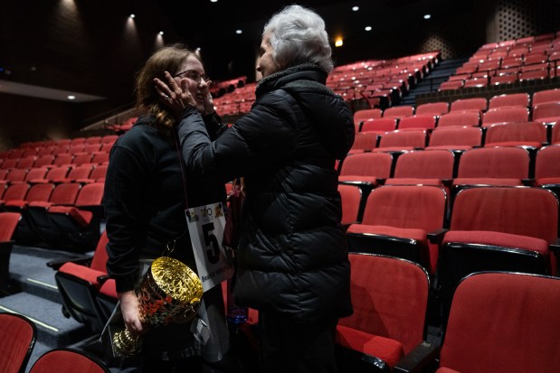 Beatriz Whitford-Rodriguez, 13, of Skinner North Classical School, hugs her grandmother, Rosa Matilde Navas, after winning the 2025 Citywide Spelling Bee Championship. (Audrey Richardson/Chicago Tribune)