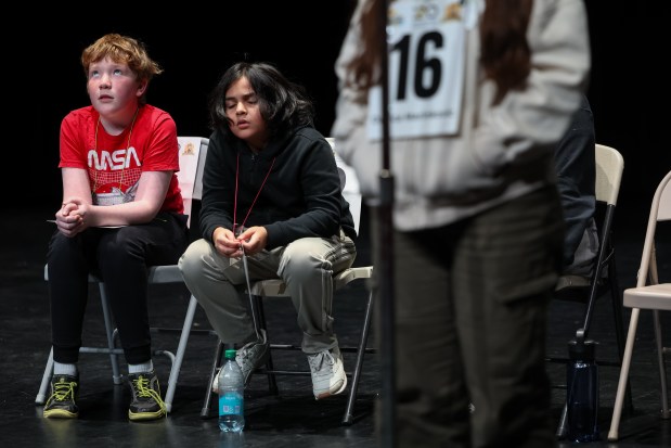 From left, Zach Bush, of Nettlehorst Elementary, Damien Kennedy, of Brennemann Elementary, wait for their turn to compete in the 2025 Citywide Spelling Bee Championship . (Audrey Richardson/Chicago Tribune)