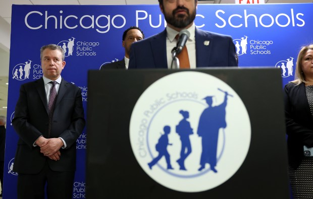 Chicago Public Schools CEO Pedro Martinez, left, stands by as CPS officials talk about recommendations from a third-party fact finder, aimed at helping them settle on a contract with the Chicago Teachers Union, during a news conference at CPS headquarters on Feb. 6, 2025. (Chris Sweda/Chicago Tribune)