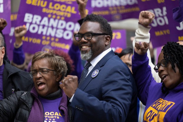 Then a candidate, Chicago Mayor Brandon Johnson greets members of SEIU Local 73 as they announce their endorsement, Nov. 9, 2022, outside City Hall in Chicago, with SEIU Local 73 President Dian Palmer. (Erin Hooley/Chicago Tribune)