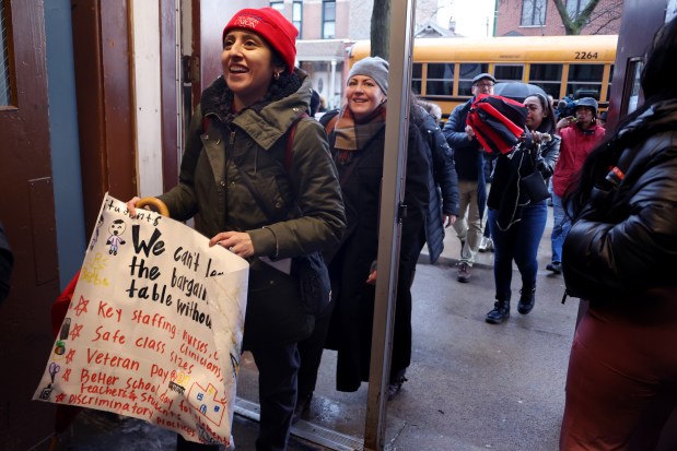 Chicago Teachers Union members march into Minnie Miñoso Academy on March 4, 2025, chanting, "Whose schools? Our schools!" (Antonio Perez/Chicago Tribune)