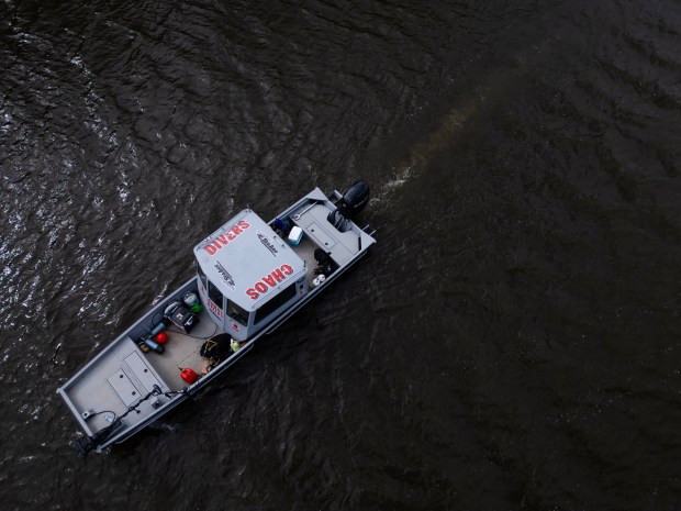 Members of the Elgin Police Department and the nonprofit organization, Chaos Divers, use sonar to search for Karen Schepers and her vehicle in the Fox River on March 24, 2025, in Elgin. The Elgin woman has been missing since 1983. (Stacey Wescott/Chicago Tribune)