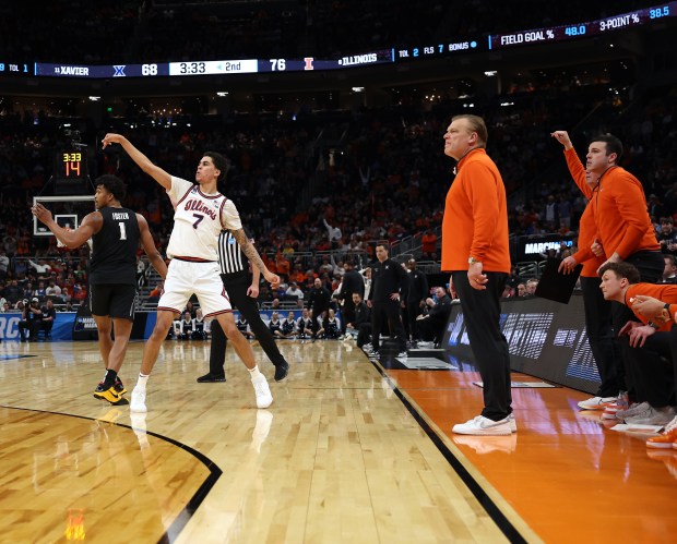 Illinois forward Will Riley (7) follows through on a 3-pointer in front of coach Brad Underwood late in the second half of an NCAA Tournament game against Xavier on March 21, 2025 m,at Fiserv Forum in Milwaukee. (Chris Sweda/Chicago Tribune)