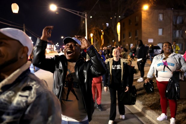 Julian Perkins reacts with joy as a lantern he released rises into the sky during a vigil to remember his nephew, Jayden Perkins, marking one year of the 11-year-old's murder in Chicago's Edgewater neighborhood on March 13, 2025. (Chris Sweda/Chicago Tribune)