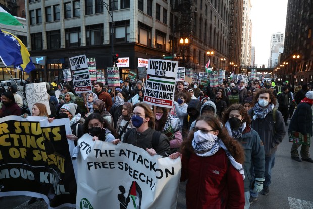 People calling for the release of activist Mahmoud Khalil, who reportedly has been detained by U.S. Immigration and Customs Enforcement, march on S. Dearborn Street in Chicago on Tuesday, March 11, 2025. Khalil played a prominent role in protests against Israel at Columbia University. (Terrence Antonio James/Chicago Tribune)