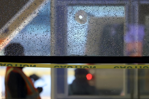 A bullet hole in a shattered window on March 12, 2025, following an early morning shooting outside Terminal 2 at O'Hare International Airport. (Antonio Perez/Chicago Tribune)