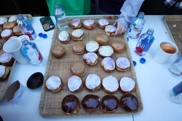 Paczki are laid out during the annual paczki eating contest at Bennison's Bakery in Evanston, March 1, 2025. (Chris Sweda/Chicago Tribune)