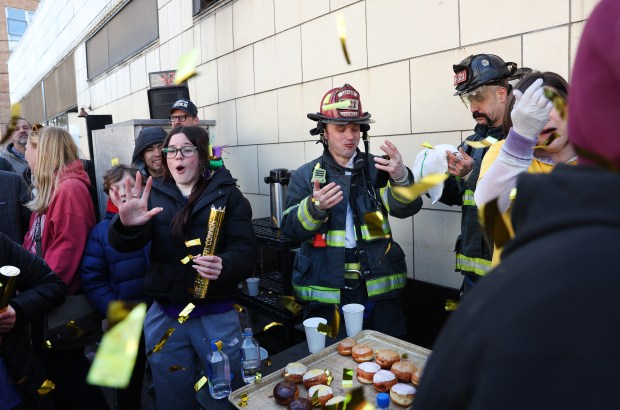 Evanston firefighter Damien Bazan reacts as the five minute period expires in the annual paczki eating contest at Bennison's Bakery in Evanston on March 1, 2025. (Chris Sweda/Chicago Tribune)