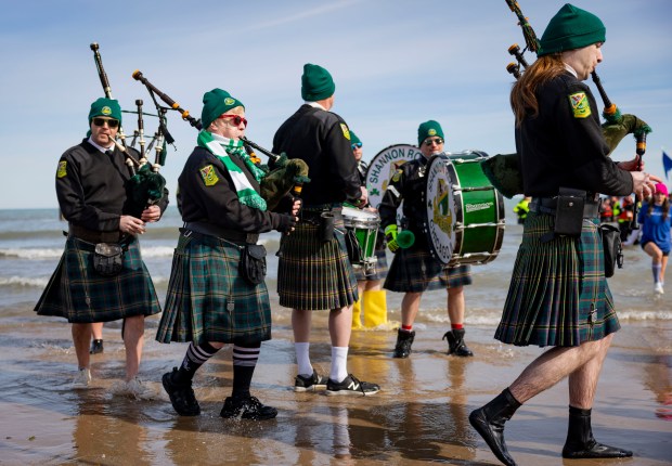 The Shannon Rovers lead participants into Lake Michigan with temperatures in the 20s on during the annual Polar Plunge benefitting Special Olympics Illinois. (Brian Cassella/Chicago Tribune)