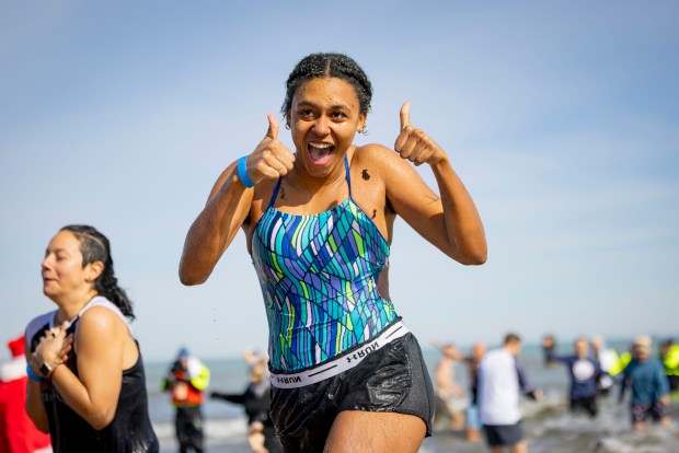 Participants run out after plunging into Lake Michigan with temperatures in the 20s during Polar Plunge Chicago. (Brian Cassella/Chicago Tribune)