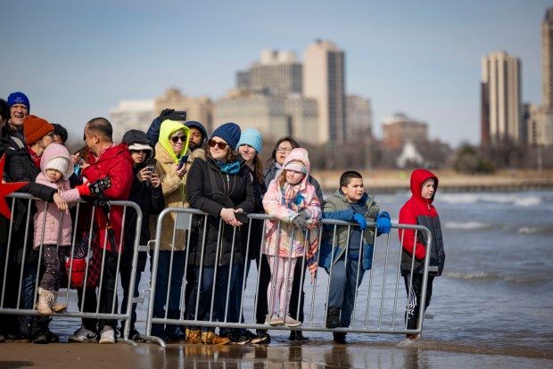 Observers wade into the water to watch participants run into Lake Michigan with temperatures in the 20s during the annual Polar Plunge benefitting Special Olympics Illinois. About 4800 people dove into the 35-degree water. (Brian Cassella/Chicago Tribune)