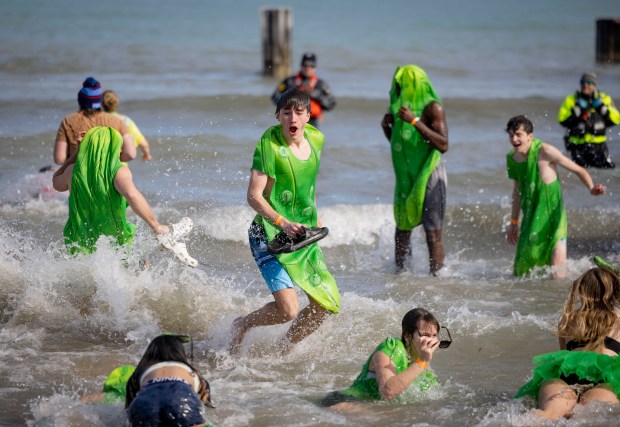 Participants splash into Lake Michigan with temperatures in the 20s during the annual Polar Plunge benefitting Special Olympics Illinois. About 4800 people dove into the 35-degree water. (Brian Cassella/Chicago Tribune)