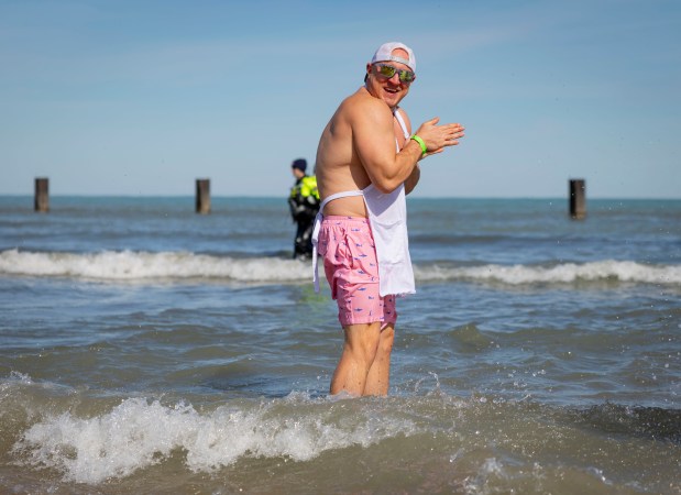 A participant keeps warm in Lake Michigan with temperatures in the 20s on March 2, 2025, at North Avenue Beach during the annual Polar Plunge benefitting Special Olympics Illinois. About 4800 people dove into the 35-degree water. (Brian Cassella/Chicago Tribune)