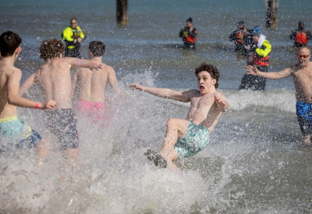 Participants jumph into Lake Michigan with temperatures in the 20s at North Avenue Beach. (Brian Cassella/Chicago Tribune)