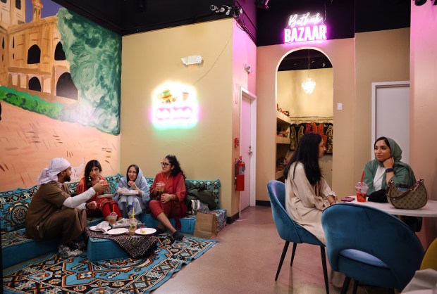 People hang out among friends and family in the early morning hours at Cafe Bethak in Lombard on March 16, 2025. (Chris Sweda/Chicago Tribune)