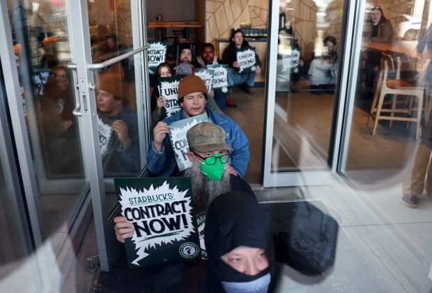 Protesters refuse to leave the Starbucks coffee shop at Ridge Avenue and Clark Street in Chicago's Edgewater neighborhood, March 11, 2025. Eleven were arrested for criminal trespass. (Chris Sweda/Chicago Tribune)