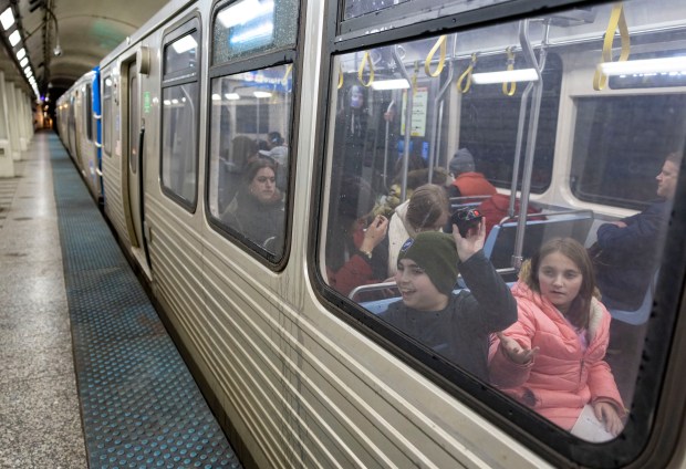 Daniel Messinger, 11, and Tamar Magid-Aloni, 10, ride a Blue Line train through the Loop subway on March 16, 2025, during their day-long attempt to stop at every CTA "L" station. (Brian Cassella/Chicago Tribune)